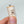 Single 1:6 miniature kitchen storage canister shown between fingers