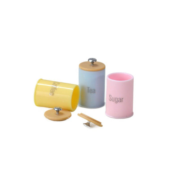 Colorful three-piece miniature kitchen storage canister set in yellow, blue, and pink