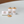 White three-piece miniature kitchen storage canister set with decorative labels