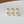 Gray three-piece miniature kitchen storage canister set with coffee, sugar, and tea labels