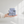 Blue striped miniature skirted armchair resting on a person's palm